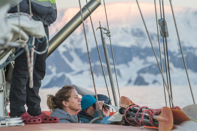 Guests taking in the Antarctic landscape from the deck of Ocean Tramp expedition vessel