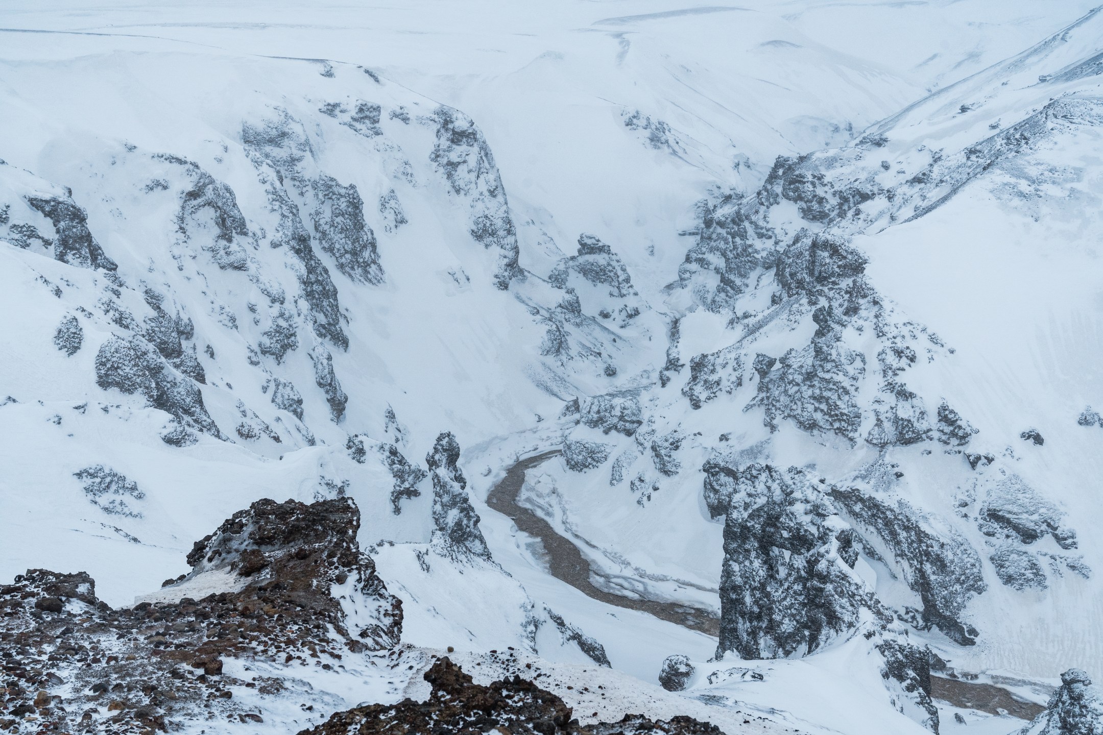 Helicopter flying over Landmannalaugar geothermal valley in winter