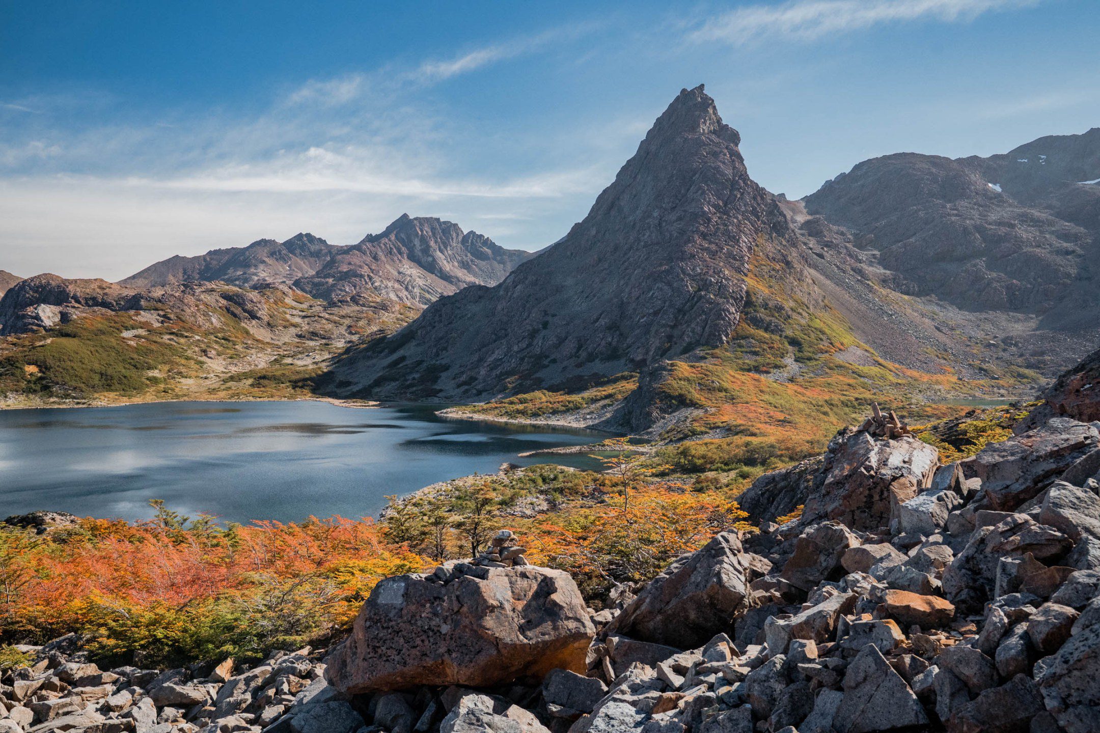 Hiking Patagonia - A dense Patagonia forest of wind-sculpted trees clings to the rocky slopes.