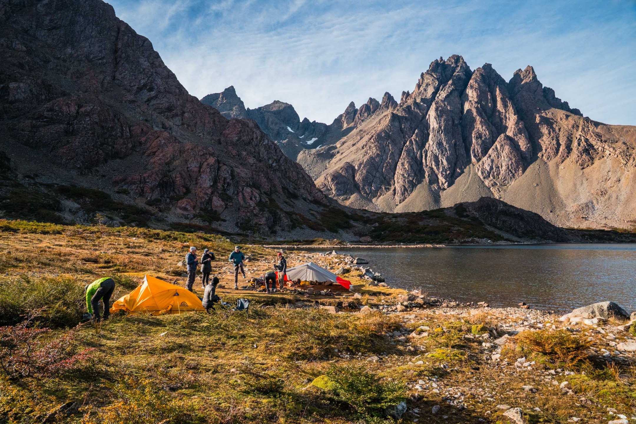 Hiking Patagonia - The sailboat securely anchored in the remote fjords of Patagonia, reflecting on the calm, glacial waters.