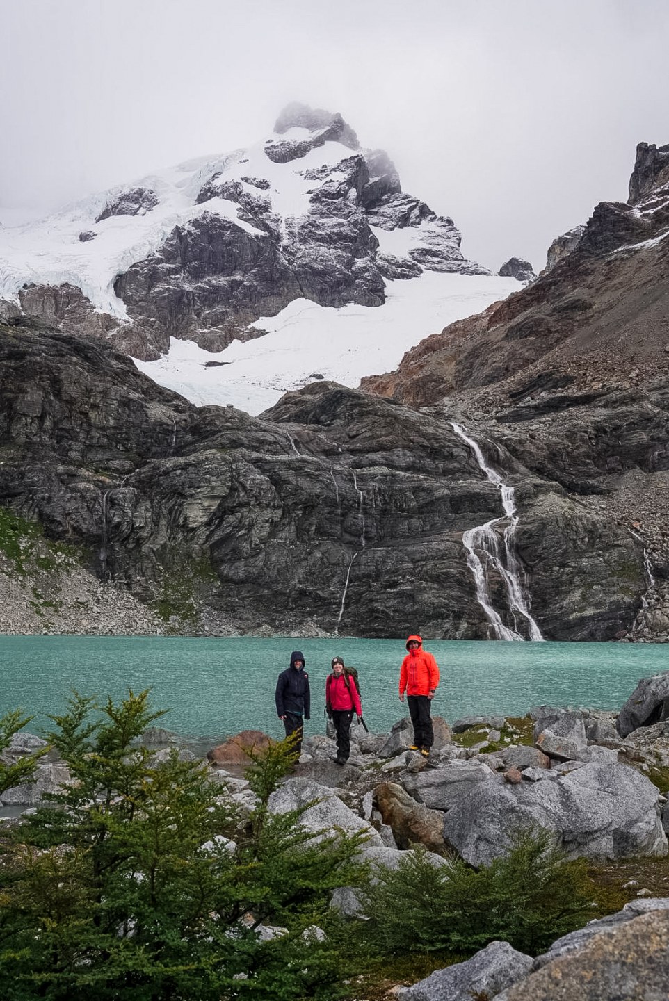 Three people in front of a lagoon in Yendegaia, Patagonia & Tierra del Fuego.